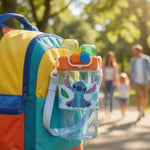 Colorful backpack with a cartoon character water bottle in a park setting