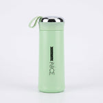 Light green vacuum flask with silver lid on a white background