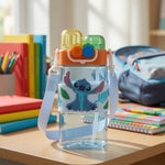 Children's water bottle with cartoon character on a desk with school supplies